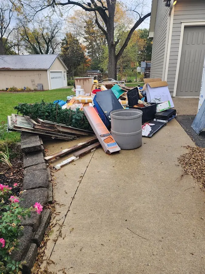 Dumpster being loaded with debris for Roofing Dumpster Rental in Hidden Meadows